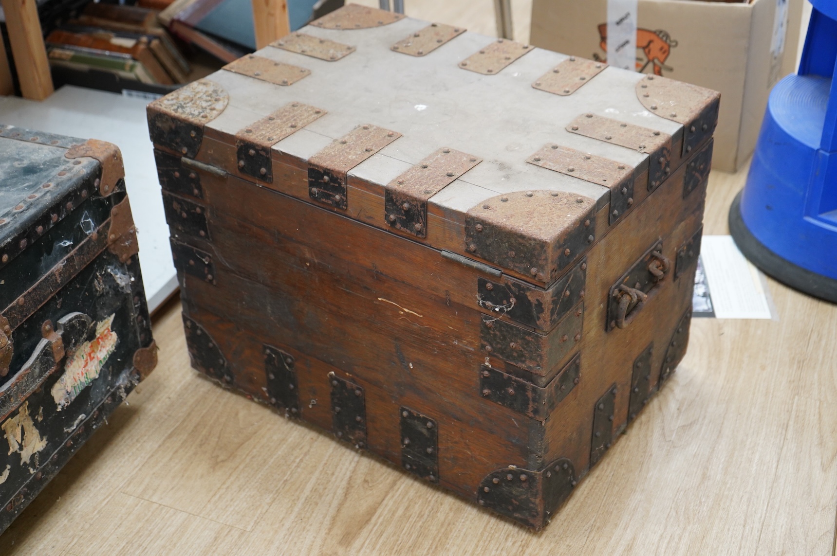 A collection of vintage luggage comprising four early 20th century bound travelling trunks and three kit bags
